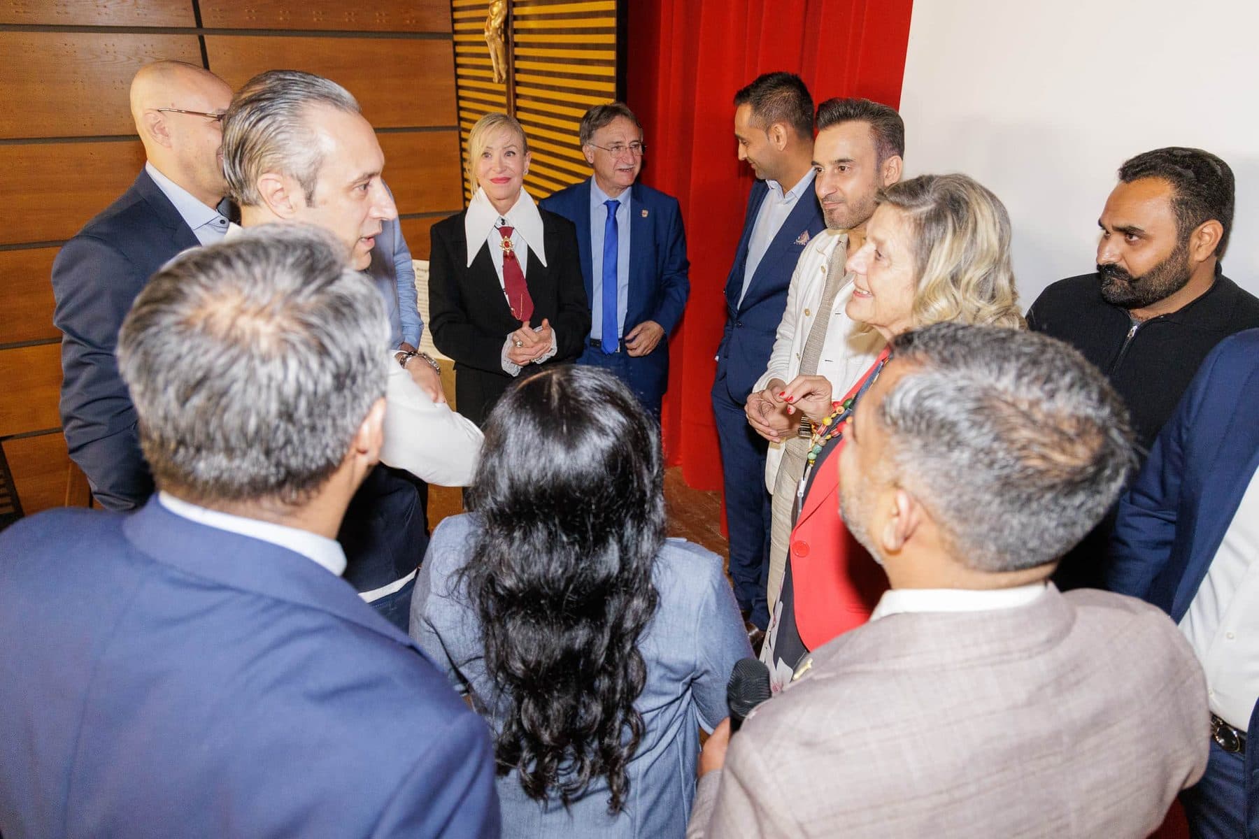 Investors in conversation after a panel