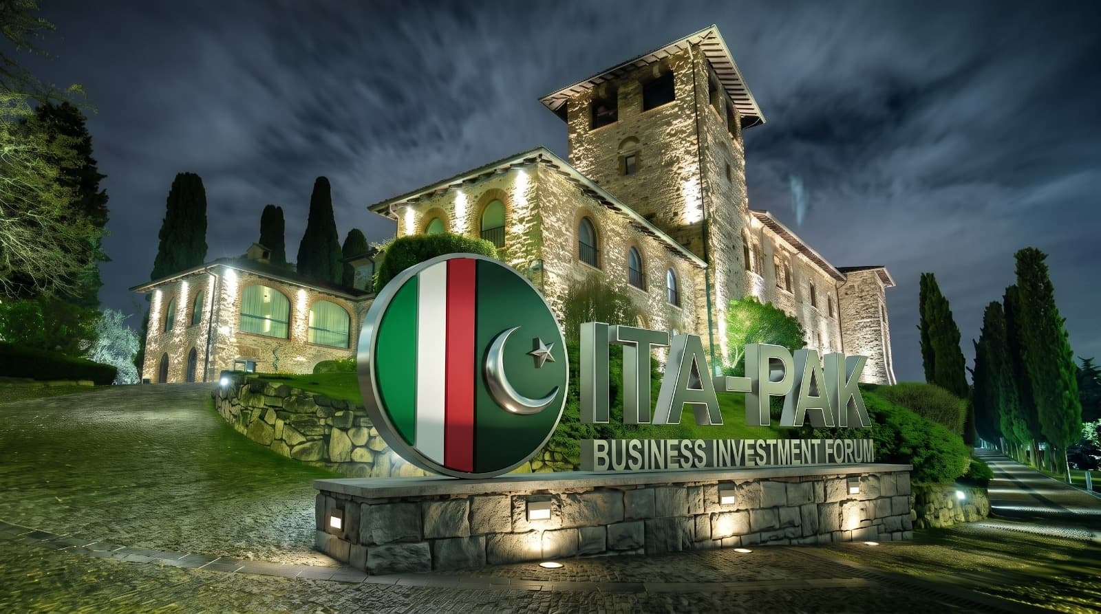 The ITA-PAK Business Investment Forum sign lit in front of Castello di Casiglio at night